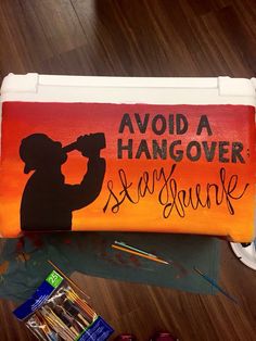 a painted canvas with the silhouette of a man holding a baseball bat and saying, avoid hangover sequins