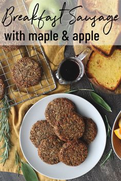 breakfast sausages with maple and apple on a plate next to bread, orange slices and coffee