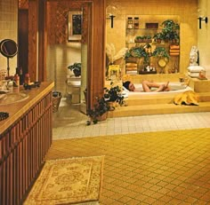 a large bathroom with a jacuzzi tub and two women in the bathtub