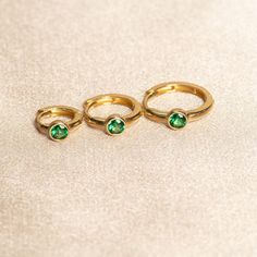 Elevate your earring stack with our exquisite gold huggies in created Emerald! These stunning created Emerald hoops are featured in a solid 14k gold bezel setting. Designed for conch piercings, helix piercings, and most other cartilage piercings, these versatile earrings add a touch of glamour and elegance to any ensemble, making them a perfect choice for those born in May or anyone looking to make a stylish statement in green. Metal: 14k Solid Yellow Gold Gemstone: Created Emerald Shape: Round Jewellery Redesign, Conch Piercings, Born In May, Gold Huggies, Earring Stack, Helix Piercings, Cartilage Piercings, Green Metal, Conch Piercing