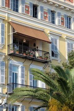 an apartment building with balconies and plants on the balcony