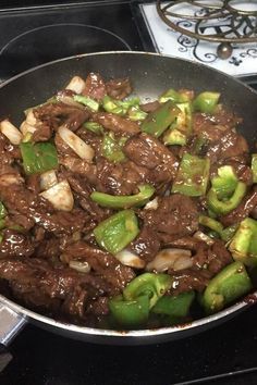 beef and peppers in a skillet on the stove