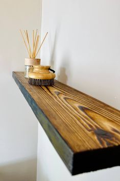 a wooden shelf with some reeds on it