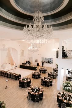 an elegant ballroom with chandeliers and tables