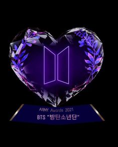 a purple heart shaped crystal award with the words bts