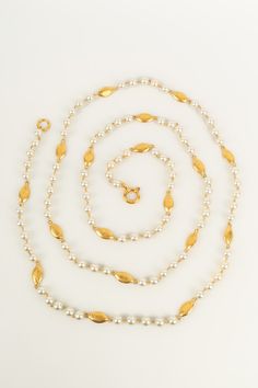 CHANEL - (Made in France) Long sautoir de perles nacrées fantaisies alternées de poissons en métal doré. Collection Automne-Hiver 2004. Condition : Très bon état Dimensions : Longueur : 218 cm Elegant Formal Pearl Necklace With Gold Beads, Formal Yellow Gold Beaded Pearl Necklace, Yellow Gold Beaded Pearl Necklace For Formal Occasions, Luxury Beaded Pearl Necklace For Evening, Ysl Shoes, Jimmy Choo Sunglasses, Dior Sunglasses, Chanel Sunglasses, Dior Shoes