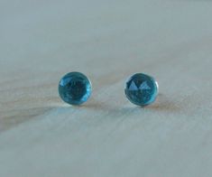 Free Shipping! 90 day guarantee! Titanium earrings studs - 6mm London Blue Topaz Rose Cut (Faceted) Cabochon Gemstones. Be a part of our online tribe! Join now and get an immediate discount of $5 off your order of $30 or more! Visit http://bit.ly/2BQxknV to sign up and you'll be redirected back here to our Etsy shop with your discount applied. These genuine rose cut London Blue Topaz gemstones are amazing to behold in this clean, modern, and sophisticated bezel setting. The pristine blue of Lond Classic Round Blue Topaz Earrings, Luxury Blue Topaz Earrings With Prong Setting, Pierced Round Blue Topaz Earrings, Blue Faceted Round Earrings, Blue Topaz Round Earrings, Tiny Gold Studs, Sensitive Ears Earrings, Silver Bar Earrings, Blue Opal Earrings