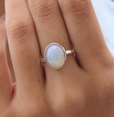 Ethiopian Opal Ring - 925 Solid Sterling Silver Ring - October Birthstone - Boho Handmade Ring - Natural Gemstone Jewellery - Gift For Her   Gemstone Name - Ethiopian Opal Gemstone . Stone Quality - AAA. Ring Weight -  3.66 g  Length  - 1.5 cm Width -  1.1 cm Stone Shape - as Shown In The Picture. Ring Size - All Ring Size Available .  All Our Jewelry is Stamped 925  We serve complete 925 sterling silver Jewelry and genuine properties of the stone, Our all products are stamped 925. Product Quality and Packaging - Our all products are 925 Silver Stamped which shows that the product is genuine and authentic .The products are dispatched from the small business from UK so you get the product on time and the product packaging comes in bubble foil wrap with all the precautions taken primarily th Minimalist Oval Cabochon Jewelry For Anniversary, White Gold Opal Gemstone Ring For Gift, Gift White Gold Opal Gemstone Ring, Silver Minimalist Opal Rings, Untreated Oval Silver Gemstones, Adjustable Cabochon Opal Ring For Anniversary, Silver Opal Birthstone Ring Gift, Oval Cabochon Opal Ring In Sterling Silver, Oval Opal Gemstone Ring For Jewelry Making