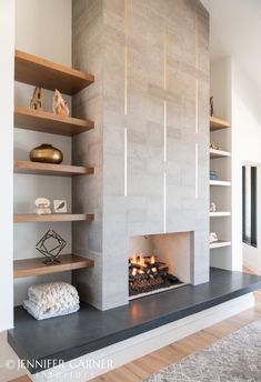 a fireplace with shelves and candles in it