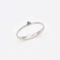 Dainty Sapphire Ring set with Natural Sapphire, size 2 millimetres diameter, 0.03 Carats. Solid 14k White Gold ☞ made to last. Click here for ☞ Solid Gold CollectionSapphire Details:• CERTIFIED Sapphire • Weight: 0.03 Carats• Dimensions: 2 millimeters• Color: Blue• Cut: Round• Origin: BurmaSetting Details:• 1.20 grams of 14k Solid White Gold• Dimensions: Band width ≈ 2.2mm, thickness ≈ 0.7mm• Non-Tarnish - Perfect for Everyday Use - Lasts a Lifetime *Final weight & dimensions depending on the ch Stackable Sapphire Diamond Ring As Gift, Dainty White Gold Birthstone Promise Ring, White Gold Dainty Birthstone Ring With Prong Setting, Sapphire Brilliant Cut Promise Ring, Dainty White Gold Birthstone Ring With Prong Setting, Delicate White Gold Birthstone Ring With Round Cut, Round Cut Silver Birthstone Ring In 14k Gold, Dainty 14k Gold Sapphire Ring With Prong Setting, Dainty 14k White Gold Sapphire Ring