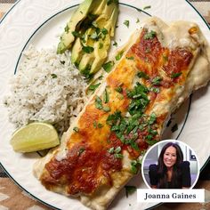 a white plate topped with fish and rice next to a slice of avocado