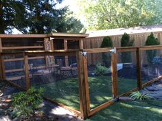 a fenced in backyard area with a chicken coop