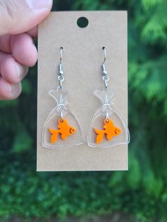 Fun dangle earrings featuring a goldfish in a bag! Laser-cut and engraved on 1/8" orange and clear acrylic. Ear hooks are stainless steel. Goldfish In Bag, Goldfish In A Bag, Earrings Acrylic, Laser Cut Earrings, Ear Hook, Acrylic Earrings, Goldfish, Clear Acrylic, Favorite Jewelry