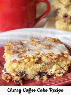 a piece of cherry coffee cake on a plate with a cup of coffee in the background