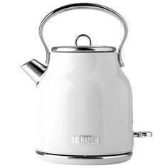 a white tea kettle sitting on top of a metal stand with the lid up and handle down