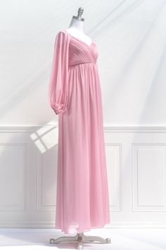 A fairytale-pink gown, the Persephone maxi dress in sparkling blush pink chiffon features a pleated bodice, long sleeves, smocked elastic back with zipper, a sweetheart neckline, and a full, sweeping skirt. Please Note- This item is final sale only. . Details: S: Bust 32"-36", Waist 26"-28", Length 58" M: Bust 34"-38", Waist 28"-30", Length 59" L: Bust 36"-40", Waist 30"-32", Length 60" Skirt Length Waist to Hem: 47" Center Back Zipper 100% Polyester Lined Dry Clean Only Imported Pink Party Dress With Gathered Sleeves, Pink V-neck Maxi Dress With Pleated Bodice, Full Length Ruched Bodice Maxi Dress For Prom, Feminine Long Sleeve Evening Dress, Long Sleeve Pleated Chiffon Party Dress, Pleated Long Sleeve Chiffon Party Dress, Long Sleeve Fitted Bodice Bridesmaid Dress For Party, Pleated Long-sleeve Chiffon Party Dress, Spring Pink Pleated Evening Dress