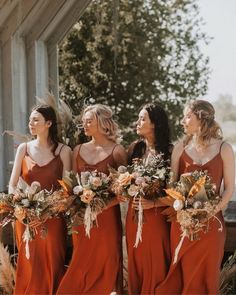 the bridesmaids are wearing orange dresses and holding bouquets in their hands while standing outside