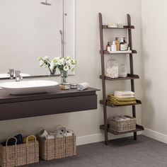 a bathroom with a sink and shelves in it