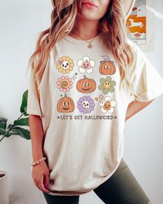 Looking for a comfortable, cute fall shirt that will make you stand out from the crowd? Look no further than our Comfort Colors retro Let's Get Halloweird t-shirt! Give it as a gift to your friends and family this fall season, or wear it yourself to show your support for all things Halloween. Comes in multiple colors! Check out more designs here: www.etsy.com/shop/jadeandroseshop ✨️SIZE AND FIT: Your shirt will be printed on a high-quality, soft and comfortable unisex t-shirt. Sizes run true to Casual Fall Shirt With Cartoon Print, Fall Cotton Shirt With Cartoon Print, Relaxed Fit Cartoon Print Top For Fall, Fun Fall Tops With Cartoon Print, Funny Orange Tops For Fall, Funny Orange Top For Fall, Funny Graphic Print Shirt For Fall, Cute Pre-shrunk Shirt For Fall, Funny Cotton Tops For Fall