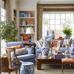 a living room filled with blue and white furniture