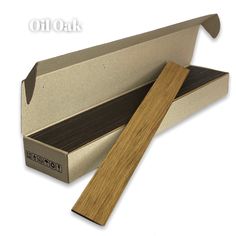 an open cardboard box with a wooden stick in it