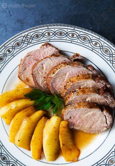 a plate with meat, bananas and parsley on it