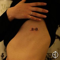 a woman's stomach with the word love tattooed on her right ribcage