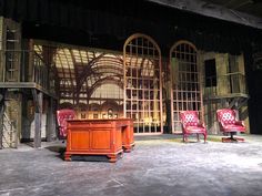 an empty stage with chairs and tables in it