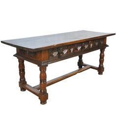 an old wooden table with carvings on the top and bottom edge, against a white background