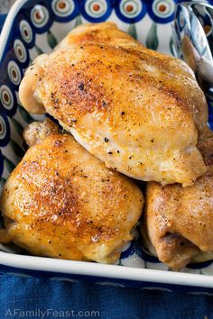 two pieces of chicken in a blue and white dish