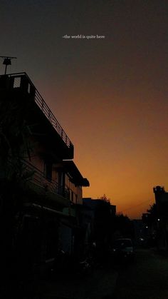 the sun is setting behind a building with a balcony and balconies on it