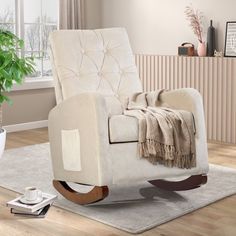 a living room with a chair, rug and potted plant