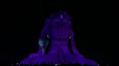 the statue is lit up with purple light