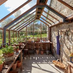 the inside of a greenhouse with potted plants