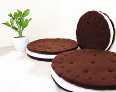 two round cushions sitting next to a potted plant