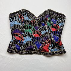 Vintage 1980s Oleg Cassini Black Tie 100% Silk Beaded And Embroidered Zip Up Corset Top Bold Jewel Toned Embroidery With Beading And Sequin Details Throughout 100% Silk Size Medium Measurements Laid Flat In Inches Bust 18 Length 13 Waist 14 Flapper Vibes Fitted Multicolor Beaded Tops, Silk Corset Top, Silk Corset, Black Tie Formal, Oleg Cassini, Bustier Top, Women Corset, Jewel Tones, Corset Top