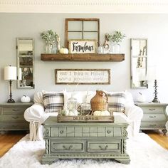 a living room filled with furniture and lots of white furnishing on top of a wooden floor