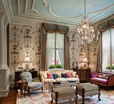 a living room filled with furniture and a chandelier