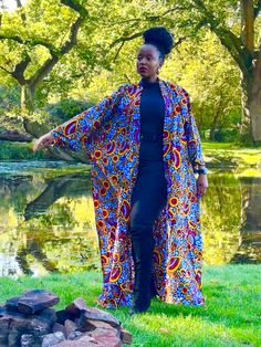 African print duster in a multi-coloured floral print. It has deep side splits and comes with a wide belt in the same fabric and can be worn with or without the belt. Wrap up securely with the same fabric belt or your favourite belt or wear as a throw on or cover up. May be dressed up or down to suit the occasion. Handmade in Ghana. 100% cotton. HAVE YOU CHECKED YOUR MEASUREMENTS AGANST THE SIZE CHART FOR THIS SHOP? Although we do our best to make sure that the colours displayed on our Website a Multicolor Floral Print Outerwear For Festival, Bohemian Belted Kimono With Kimono Sleeves, Bohemian Belted Kimono, Fitted Floral Kimono For Festival, Long Kimono With Vibrant Print For Festival, Floral Print Maxi Length Kimono For Festival, Maxi Length Floral Kimono For Festival, Festival Floral Print Maxi Kimono, Fitted Floral Print Kimono