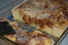 a close up of a cake in a pan with a spatula