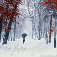 a person walking in the snow with an umbrella