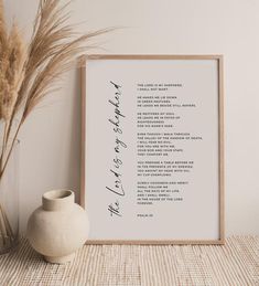 a white vase sitting next to a framed poem