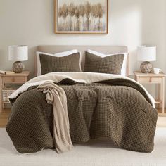 a bed in a bedroom with brown and white comforter