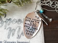 a silver spoon sitting on top of a table next to a christmas tree