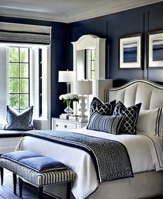 a bedroom with blue walls and white furniture