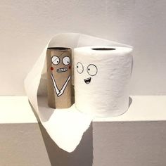 two toilet paper rolls with faces drawn on them