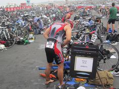 a large group of people standing around with bikes on the ground in front of them