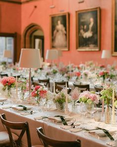 a long table is set with flowers and candles for a formal dinner or banquet event