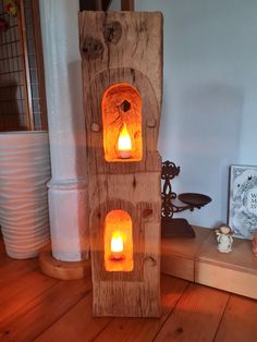 a wooden tower with two lit candles in it