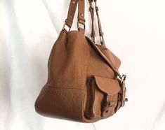 Brown Saddle Bag With Adjustable Strap For Office, Brown Office Saddle Bag With Adjustable Strap, Designer Brown Bag With Detachable Strap, Designer Brown Shoulder Bag For Shopping, Designer Hobo Bag For Everyday, Designer Everyday Hobo Shoulder Bag, Designer Saddle Bag With Adjustable Strap, Designer Saddle Bag With Removable Pouch For Everyday, Designer Saddle Bag With Adjustable Strap For Everyday Use